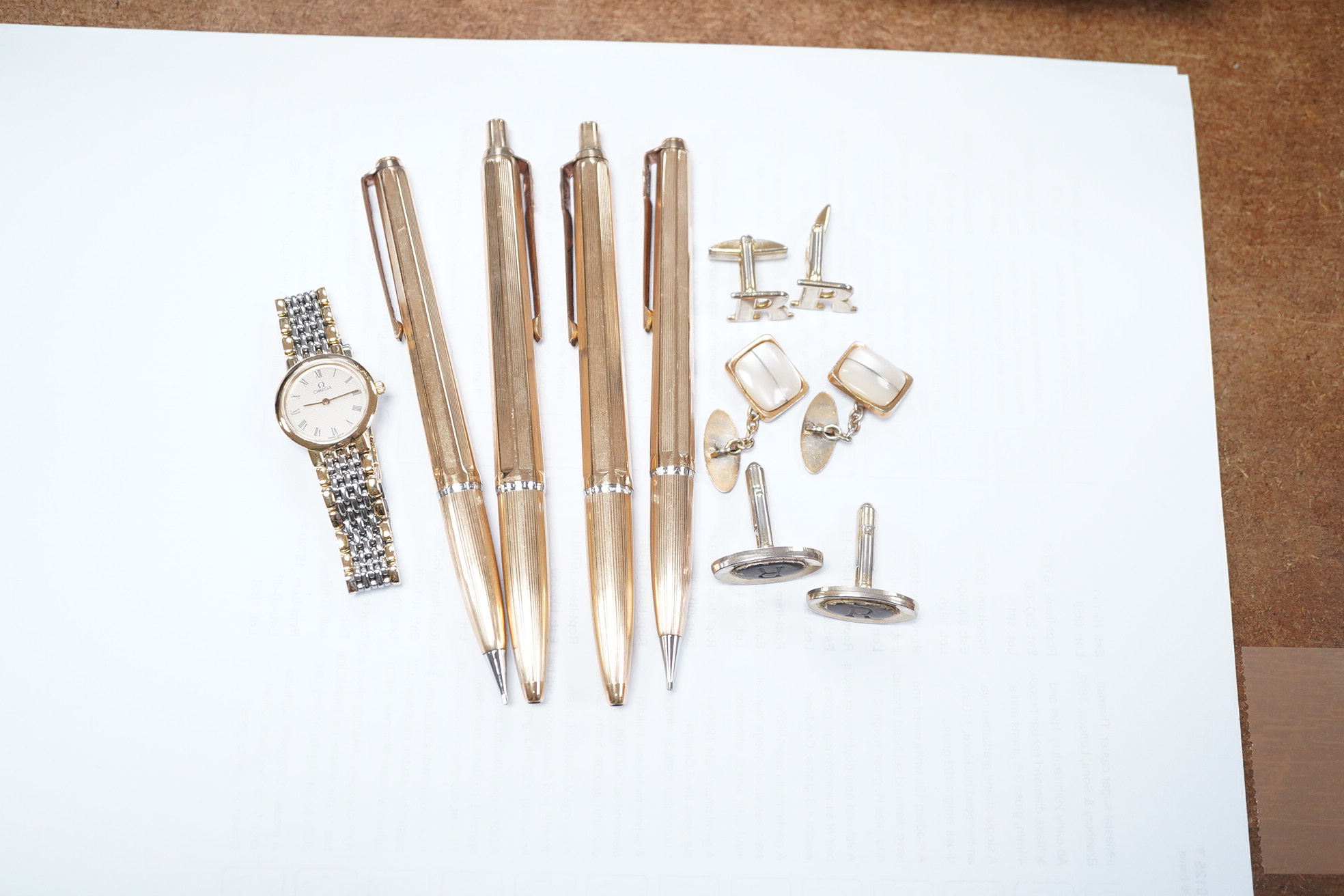 Sundry items comprising, four gold plated pens, cuff links, Omega lady's watch. Condition - fair to good